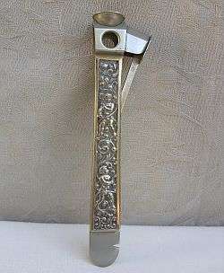 A VINTAGE CIGAR CUTTER WITH CHERUB DESIGN