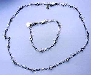 A MATCHING STERLING SILVER BRACELET AND NECKLACE WITH CLEAR STONES - MADE WITH LOVE