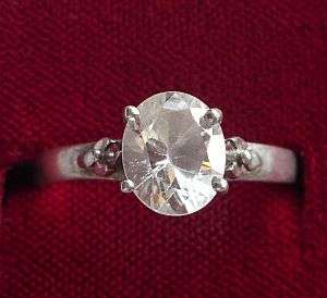 A STERLING SILVER RING SET WITH A SINGLE FACETED CZ