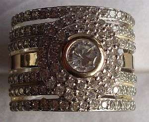 A GLAMOROUS WIDE BAND STERLING SILVER RING SET WITH "TONS" OF FACETED CZ STONES