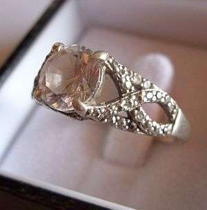 STRIKINGLY ATTRACTIVE STERLING SILVER RING WITH MANY FACETED STONES
