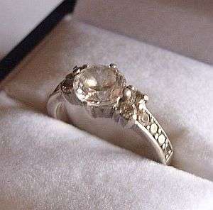A STERLING SILVER RING SET WITH MULTIPLE FACETED CZ STONES