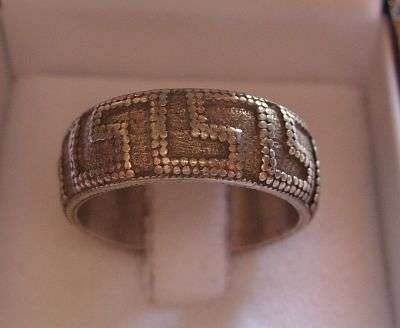 24 HOUR AUCTION !!!! A SOLID STERLING SILVER RING WITH AZTEC DECORATION
