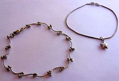 TWO STERLING SILVER BRACELETS / ONE WITH A STAR CHARM