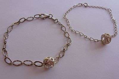 TWO STERLING SILVER BRACELETS / BOTH WITH "BALL" CHARMS