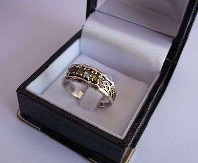 A SOLID STERLING SILVER RING SET WITH 4 FACETED GEMS - AMETHYST , PERIDOT ? ETC ETC