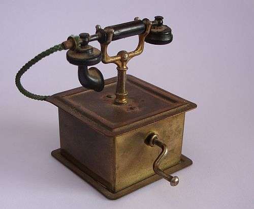 A VINTAGE MINIATURE MODEL OF AN ANTIQUE TELEPHONE