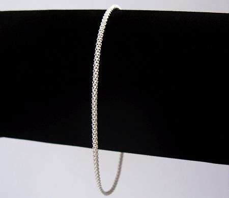 A DELICATE WOVEN LOOK STERLING SILVER BRACELET