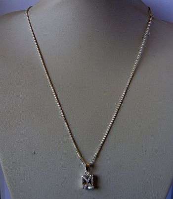 AN ELEGANT STERLING SILVER NECKLACE WITH A STERLING SILVER PENDANT SET WITH A FACETED CLEAR STONE !!