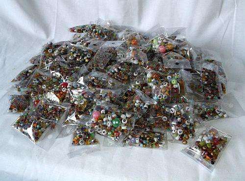 100 JAM PACKED PACKETS OF ASSORTED BEADS ...GLASS ... WOOD ...ACRYLIC ....ETC ...ETC ...BID PER PACK