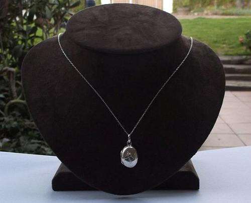 A FANTASTIC STERLING SILVER LOCKET WITH INCISED DECORATION PLUS A STERLING SILVER NECKLACE ...WOW !!