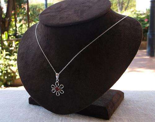 A DAINTY STERLING SILVER NECKLACE AND " FLOWERY " PENDANT SET WITH A FACETED RED STONE ...SWEET !!!