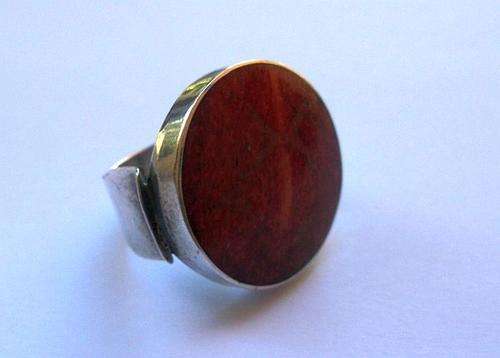 AN EYE CATCHING STERLING SILVER RING SET WITH A BIG RED GEMSTONE ....POSSIBLY RED JASPER ...AWESOME