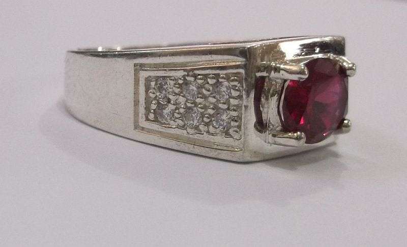 Brilliant Quality solid Sterling Silver ring with 12 clear faceted stones and one red faceted stone