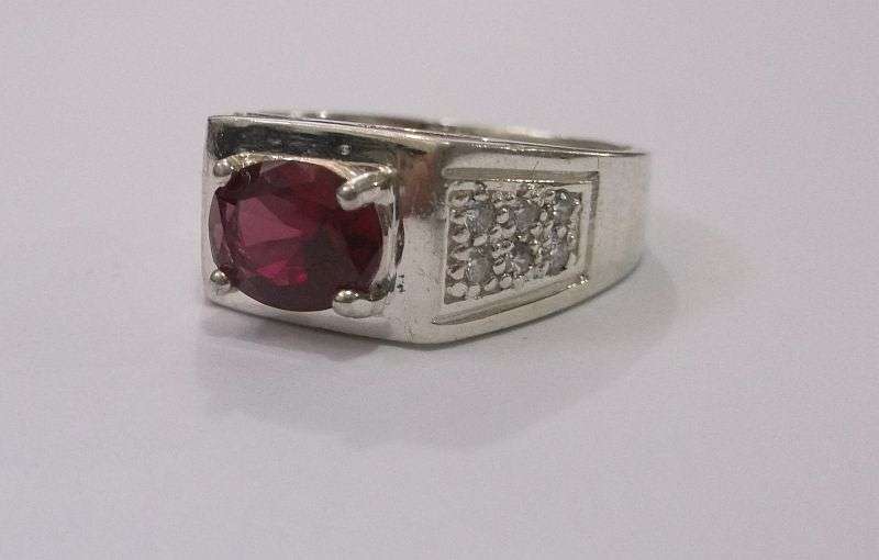 Brilliant Quality solid Sterling Silver ring with 12 clear faceted stones and one red faceted stone