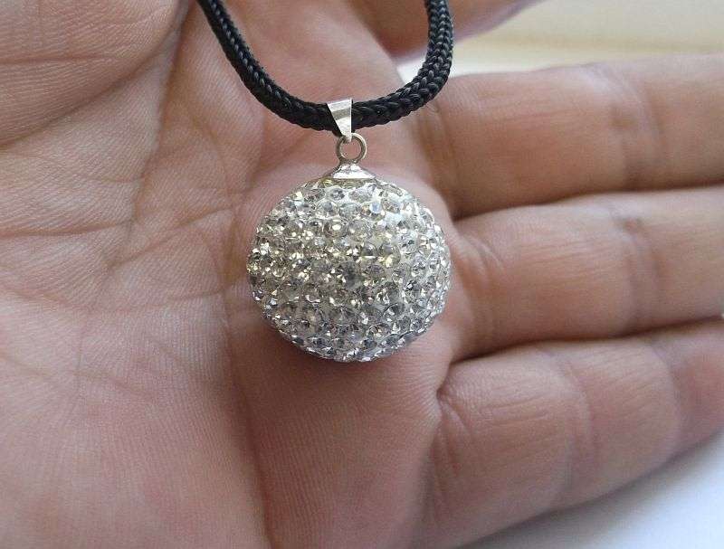 An extraordinary Disco ball style sterling silver pendant set with multiple faceted clear stones