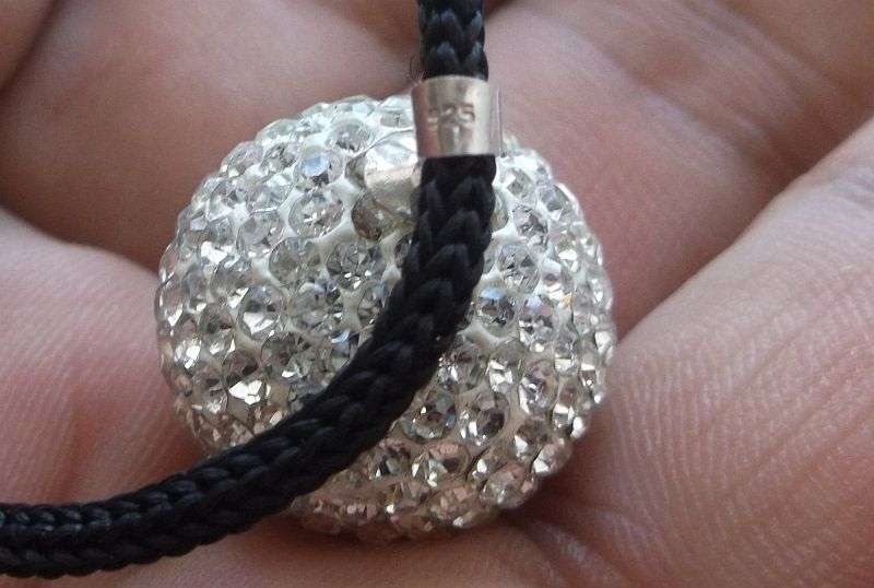 An extraordinary Disco ball style sterling silver pendant set with multiple faceted clear stones