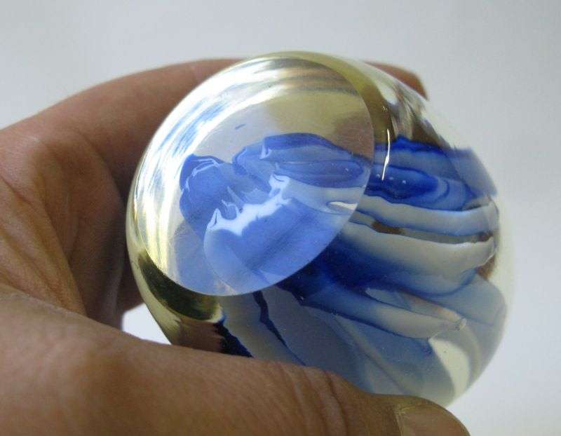 AN EYE CATCHING VINTAGE SOLID GLASS PAPERWEIGHT WITH BLUE AND WHITE LAVA STYLE DETAIL ...WOW !!