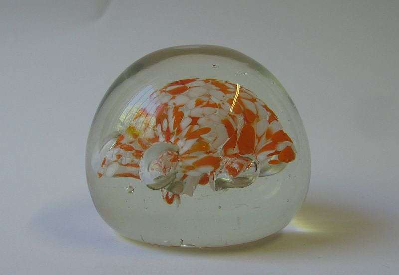 A COOL LOOKING VINTAGE SOLID GLASS PAPERWEIGHT WITH WHITE AND ORANGE SPECKLES DETAIL...NICE !!