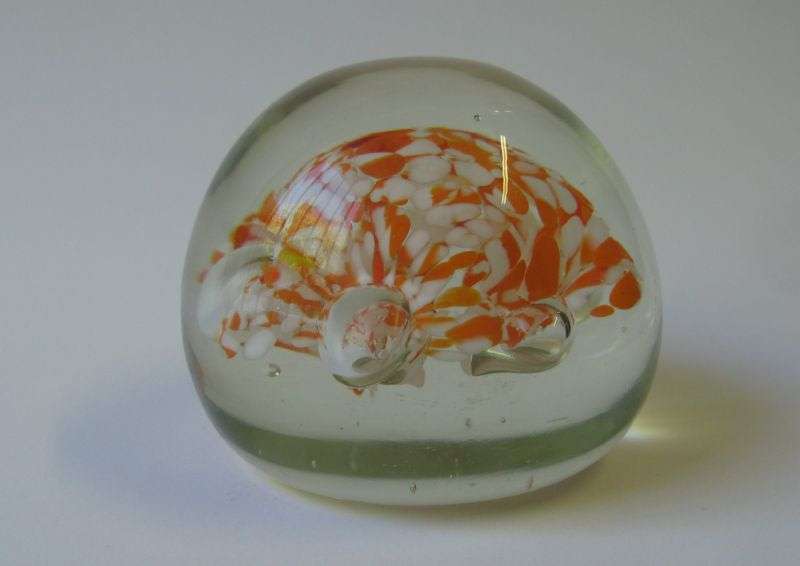 A COOL LOOKING VINTAGE SOLID GLASS PAPERWEIGHT WITH WHITE AND ORANGE SPECKLES DETAIL...NICE !!