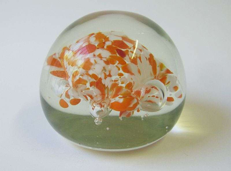 A COOL LOOKING VINTAGE SOLID GLASS PAPERWEIGHT WITH WHITE AND ORANGE SPECKLES DETAIL...NICE !!