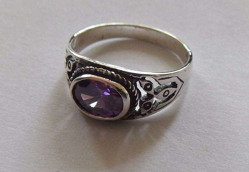 A Great Quality Solid Sterling Silver ring set with an Amethyst colored Cubic Zirconia !! WoW !!
