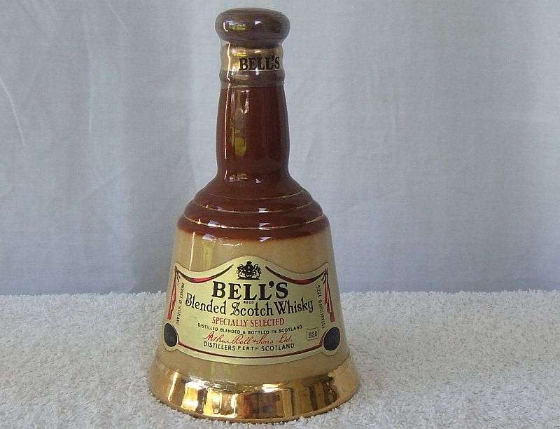 200 ML OF THE BEST !! A VINTAGE ""BELLS WHISKY"" IN A WADE PORCELAIN "BELL" SHAPED DECANTER - SEALED