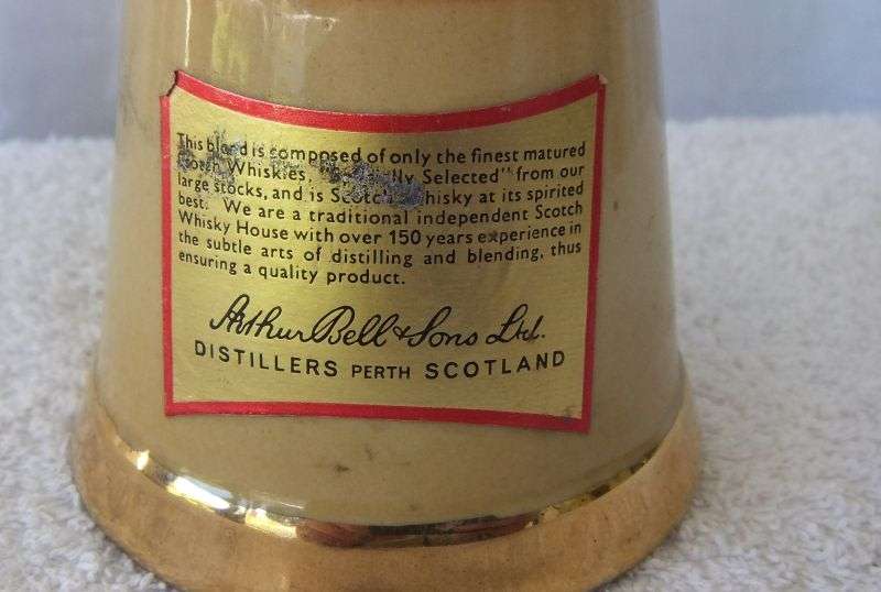 200 ML OF THE BEST !! A VINTAGE ""BELLS WHISKY"" IN A WADE PORCELAIN "BELL" SHAPED DECANTER - SEALED