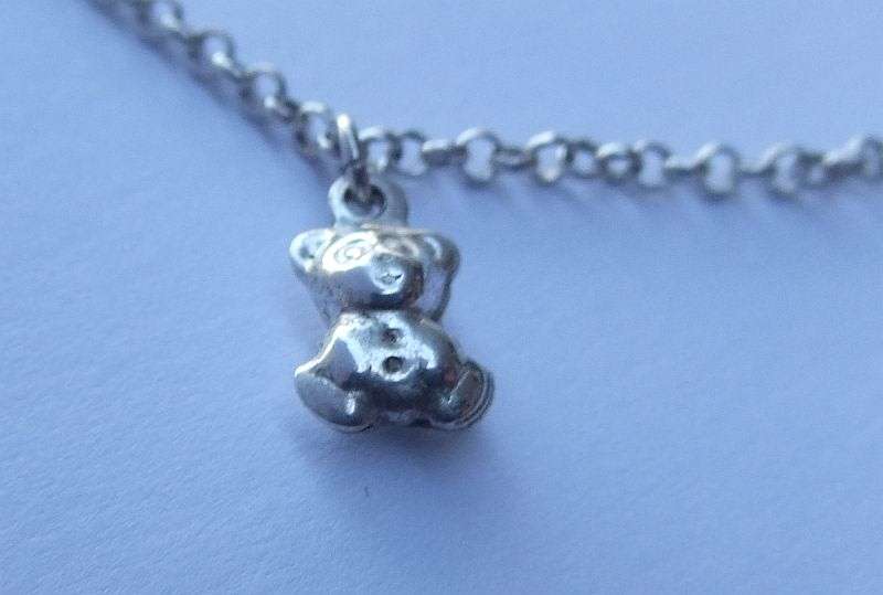 A FABULOUS ROUND LINK STERLING SILVER BRACELET WITH FOUR HOLLOW STARTER CHARMS , QUALITY CLASP !!