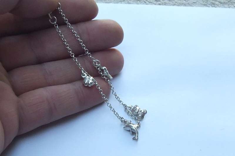 A FABULOUS ROUND LINK STERLING SILVER BRACELET WITH FOUR HOLLOW STARTER CHARMS , QUALITY CLASP !!