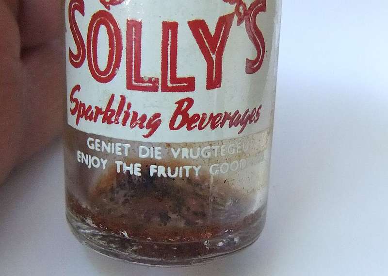 MADE IN KRUGERSDORP !! BILINGUAL ADVERTISING !!  A VINTAGE MINIATURE "SOLLY`S" COOLDRINK BOTTLE