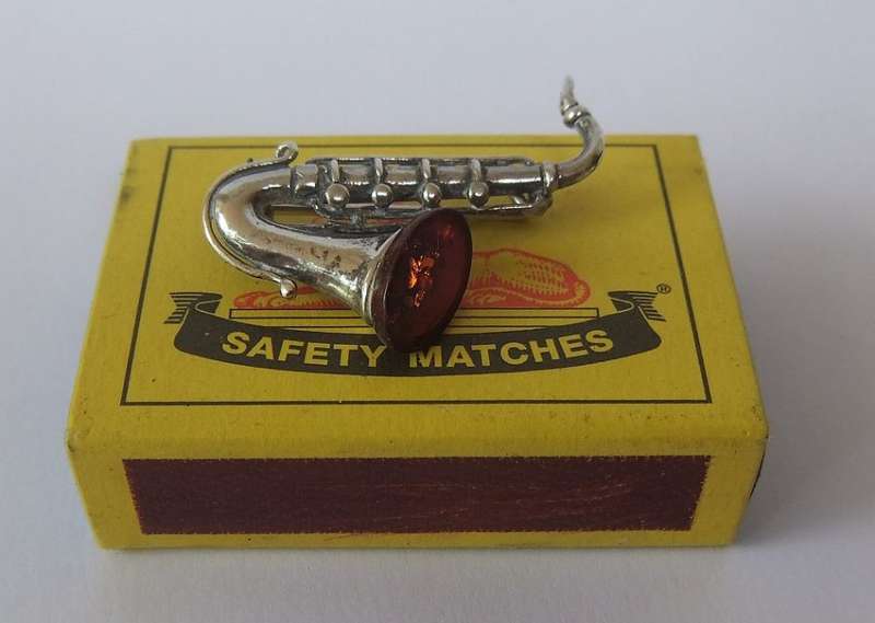 A GORGEOUS INTERESTING WELL MADE VINTAGE STERLING SILVER AND GENUINE AMBER DESIGNER SAXOPHONE BROOCH