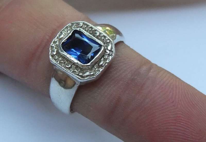 TIMELESS !! A BEAUTIFULLY DESIGNED SOLID STERLING SILVER RING SET WITH A FACETED BLUE STONE !! WOW !