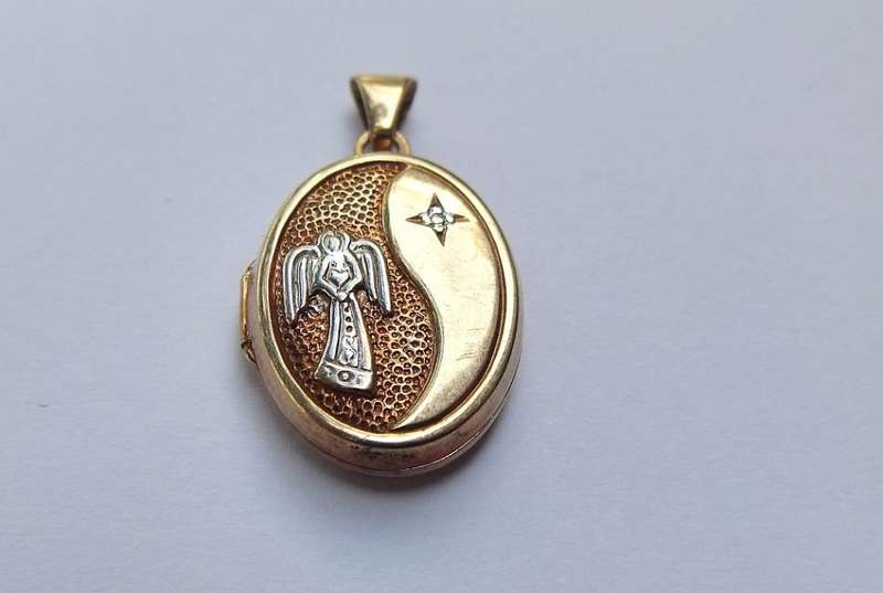 A VINTAGE 9CT GOLD "GUARDIAN ANGEL" LOCKET - STAMPED AND TESTED