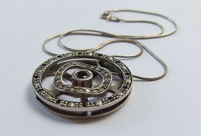 A STYLISH STERLING SILVER "WHEEL" PENDANT SET WITH VARIOUS STONES PLUS A STERLING SILVER NECKLACE !!