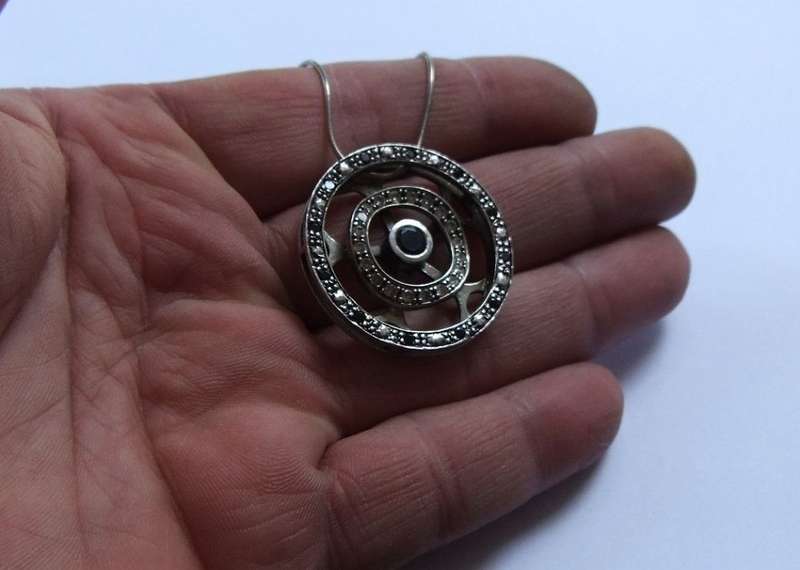 A STYLISH STERLING SILVER "WHEEL" PENDANT SET WITH VARIOUS STONES PLUS A STERLING SILVER NECKLACE !!