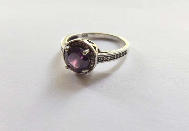 A CLASSY SOLID STERLING SILVER RING SET WITH A FACETED PURPLE STONE AND SMALL CLEAR STONES !! TESTED
