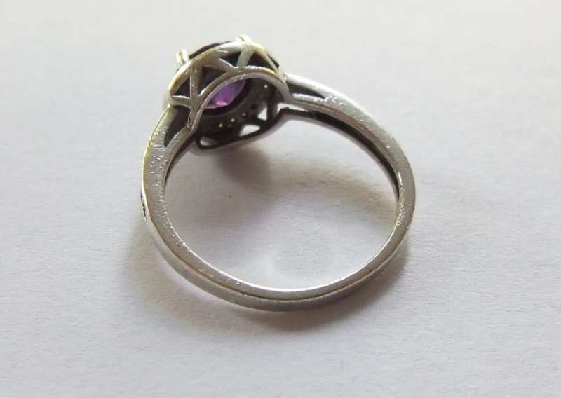 A CLASSY SOLID STERLING SILVER RING SET WITH A FACETED PURPLE STONE AND SMALL CLEAR STONES !! TESTED