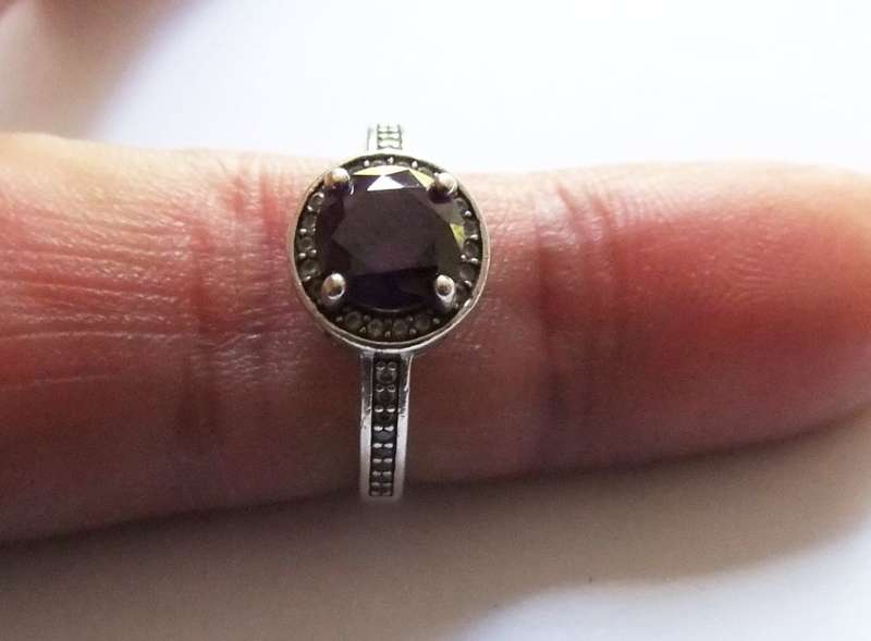 A CLASSY SOLID STERLING SILVER RING SET WITH A FACETED PURPLE STONE AND SMALL CLEAR STONES !! TESTED