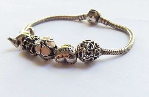 WOW ! OVER R3000 VALUE !! A GENUINE PANDORA SOLID STERLING SILVER CHARM BRACELET WITH FIVE CHARMS !!