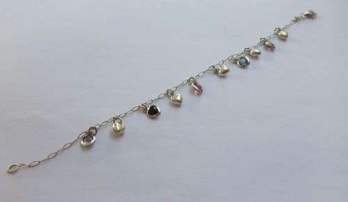 WOW !! AN EYE CATCHING SOLID STERLING SILVER CHARM BRACELET WITH ALLOT OF HEART !! I MEAN HEARTS !!