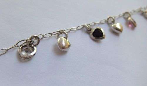 WOW !! AN EYE CATCHING SOLID STERLING SILVER CHARM BRACELET WITH ALLOT OF HEART !! I MEAN HEARTS !!