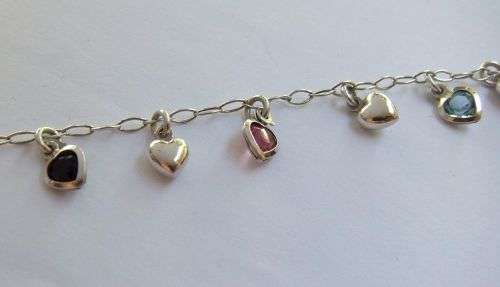 WOW !! AN EYE CATCHING SOLID STERLING SILVER CHARM BRACELET WITH ALLOT OF HEART !! I MEAN HEARTS !!