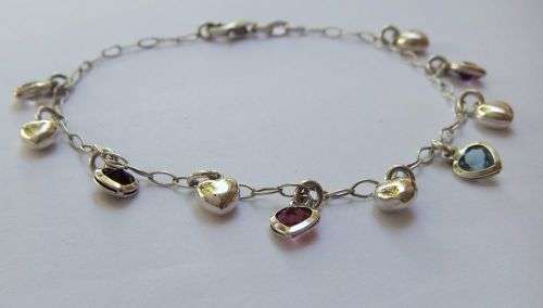 WOW !! AN EYE CATCHING SOLID STERLING SILVER CHARM BRACELET WITH ALLOT OF HEART !! I MEAN HEARTS !!
