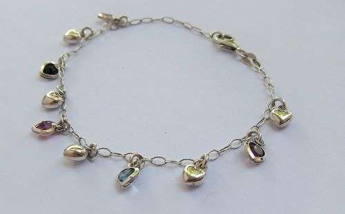 WOW !! AN EYE CATCHING SOLID STERLING SILVER CHARM BRACELET WITH ALLOT OF HEART !! I MEAN HEARTS !!