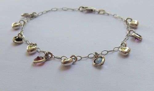 WOW !! AN EYE CATCHING SOLID STERLING SILVER CHARM BRACELET WITH ALLOT OF HEART !! I MEAN HEARTS !!