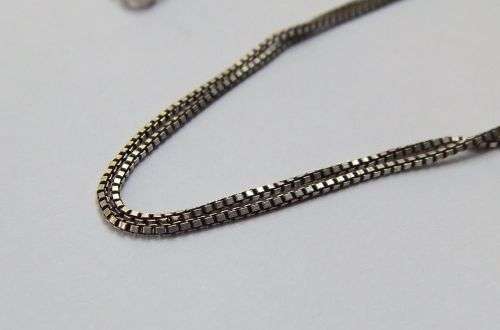 A CHARMING SOLID STERLING SILVER PENDANT SET WITH A FACETED RED STONE PLUS STERLING SILVER NECKLACE