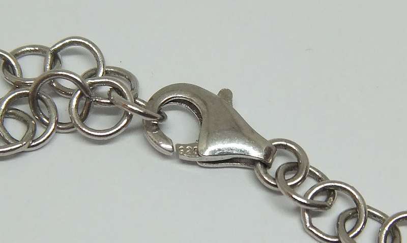 A MAGNIFICENT DESIGNER STERLING SILVER BRACELET SET WITH FACETED BLUEISH PEAR SHAPED STONES !! WOW !
