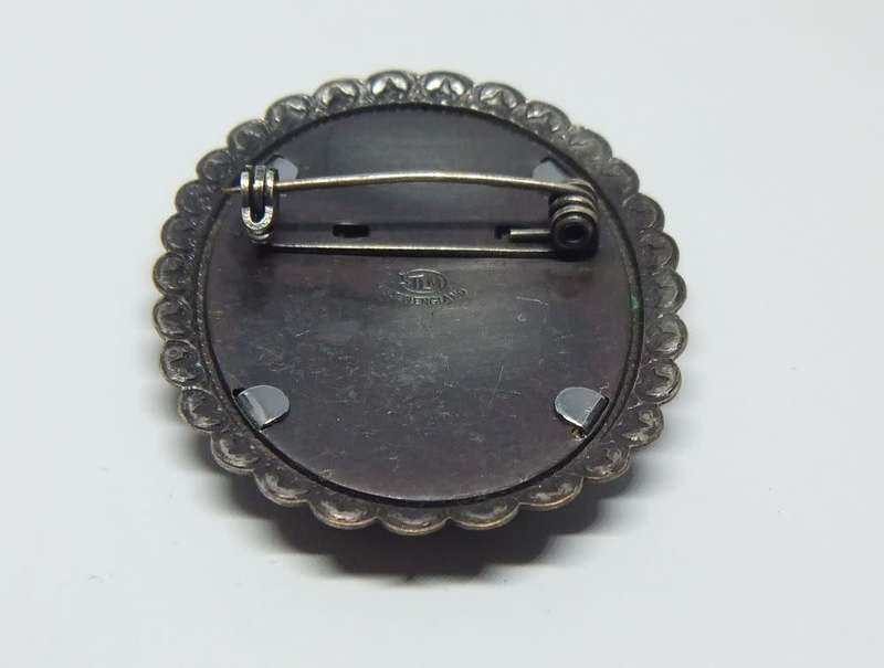 A vintage silver tone brooch designed by Thomas L Mott made in England