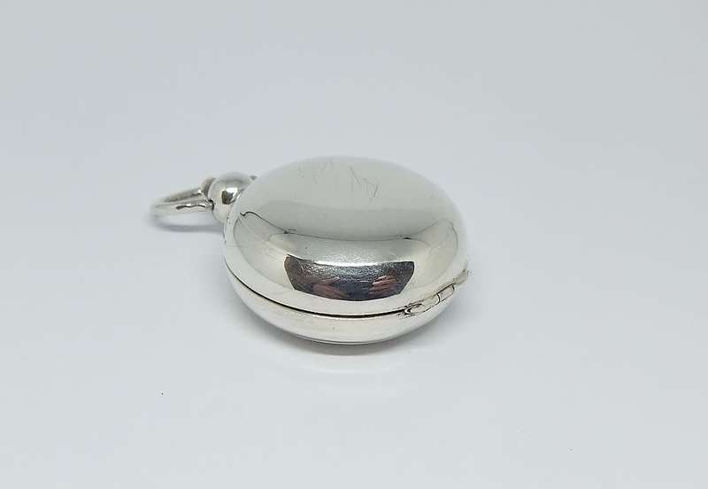 A vintage Birmingham hallmarked  sterling silver pill holder fob with spring action clip